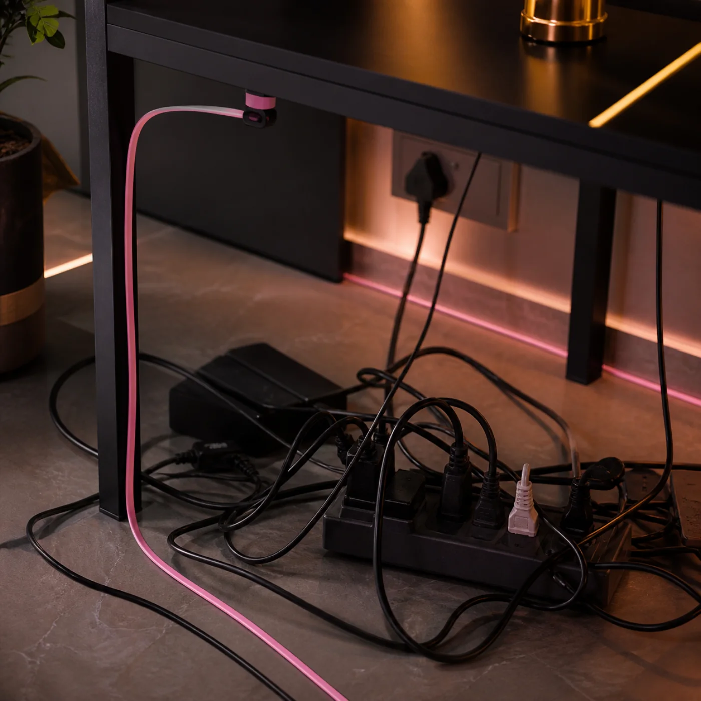 Tangled cables beneath a desk