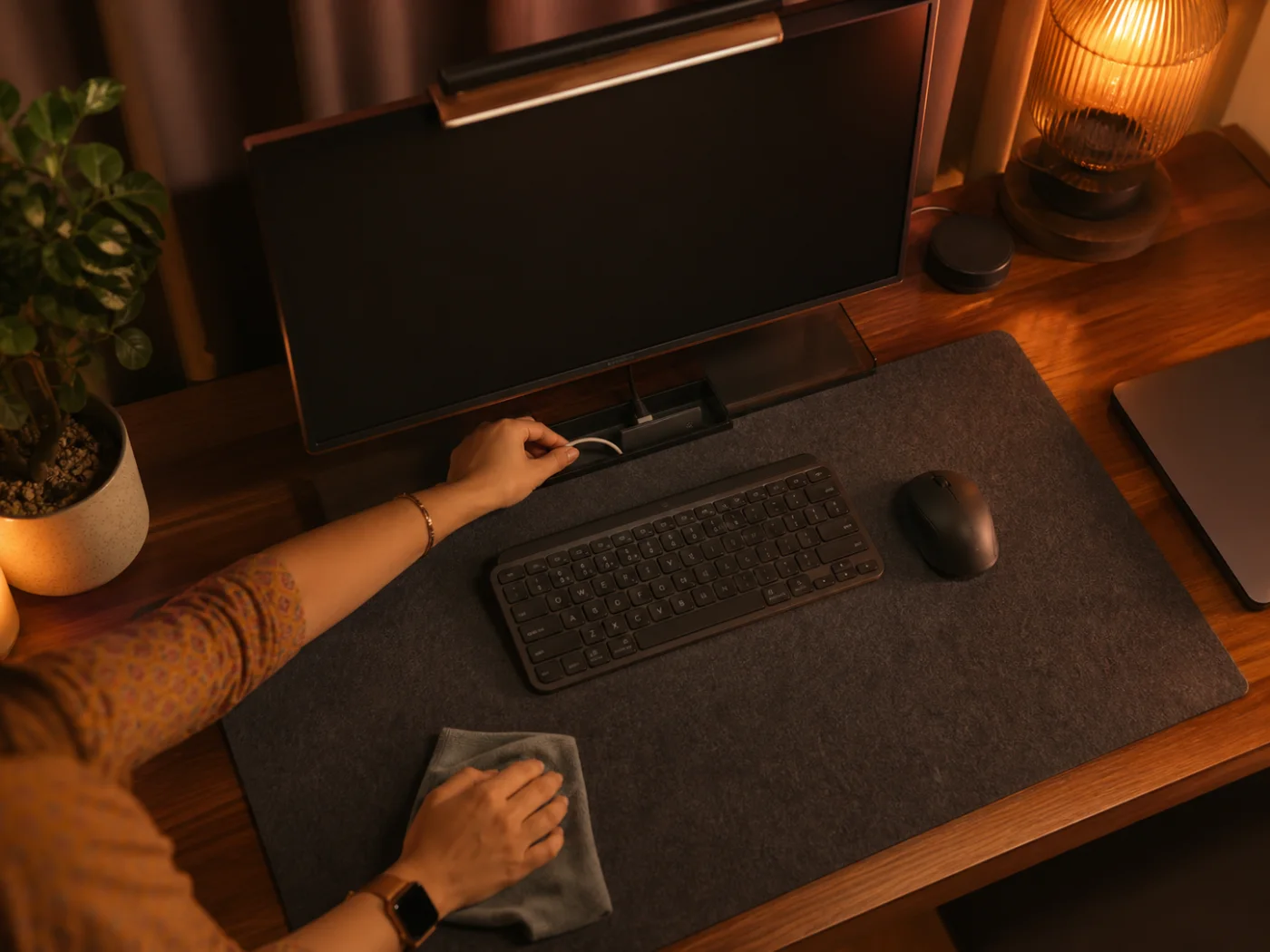 Hands tidying a desk at shutdown